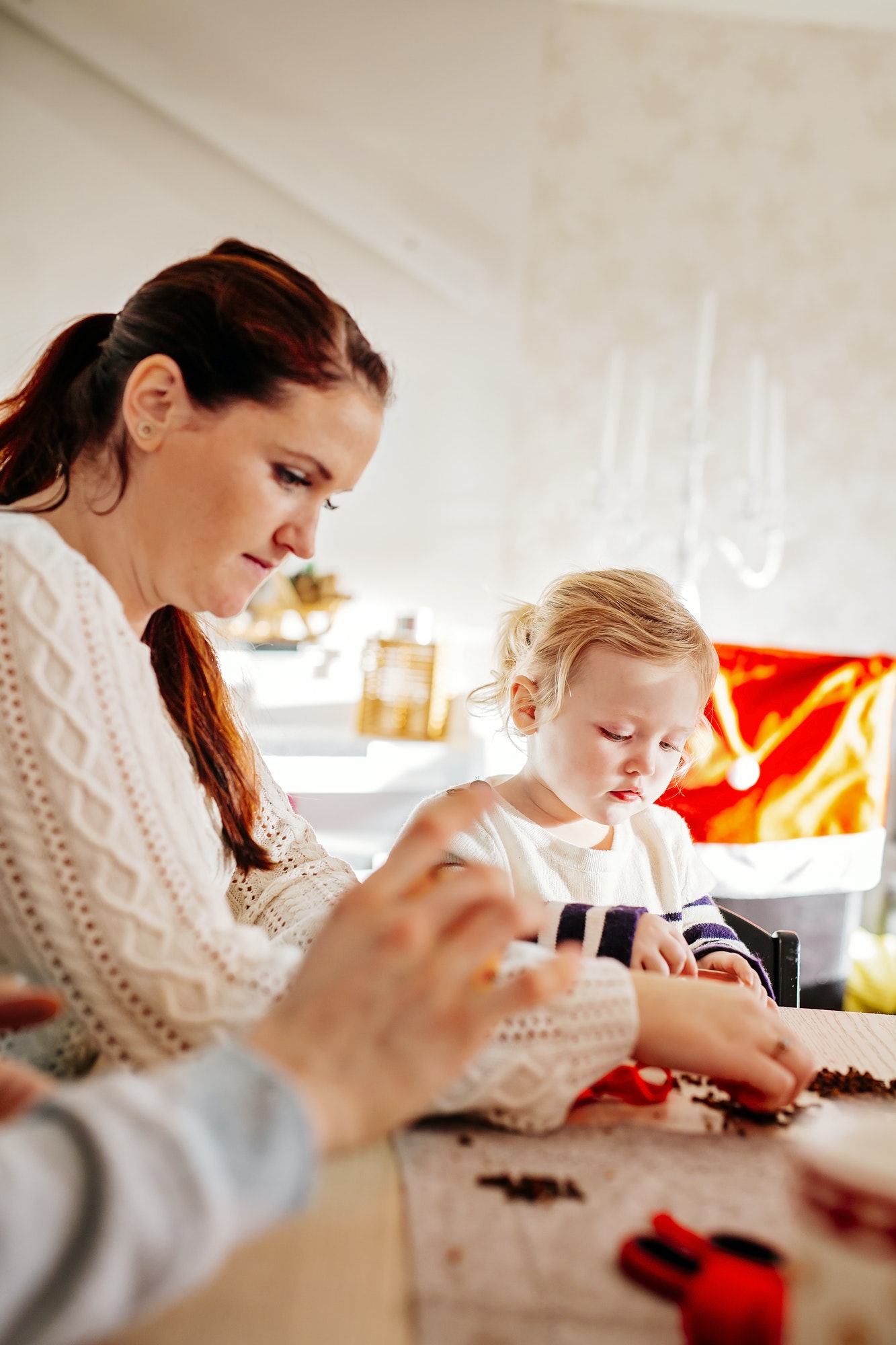 Family preparing Christmas decorations while sitting at table